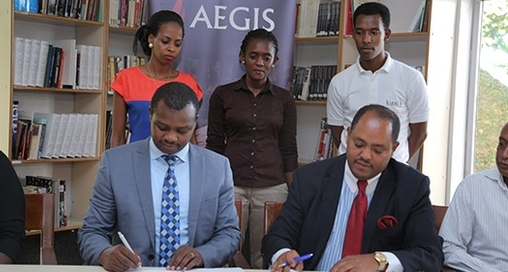 Freddy Mutanguha of the Aegis Trust signs MoU with Ambassador Mussie Hailu for URI Africa